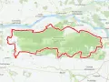 Mapa z zaznaczonym Kampinoskim Szlakiem Rowerowym, biegnącym przez Kampinoski Park Narodowy, w pobliżu Wisły i miejscowości takich jak Zakroczym czy Ożarów Mazowiecki.