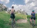 Rowerzyści podziwiają ruiny zamku na Szlaku Orlich Gniazd. Malowniczy krajobraz Jury Krakowsko-Częstochowskiej.
